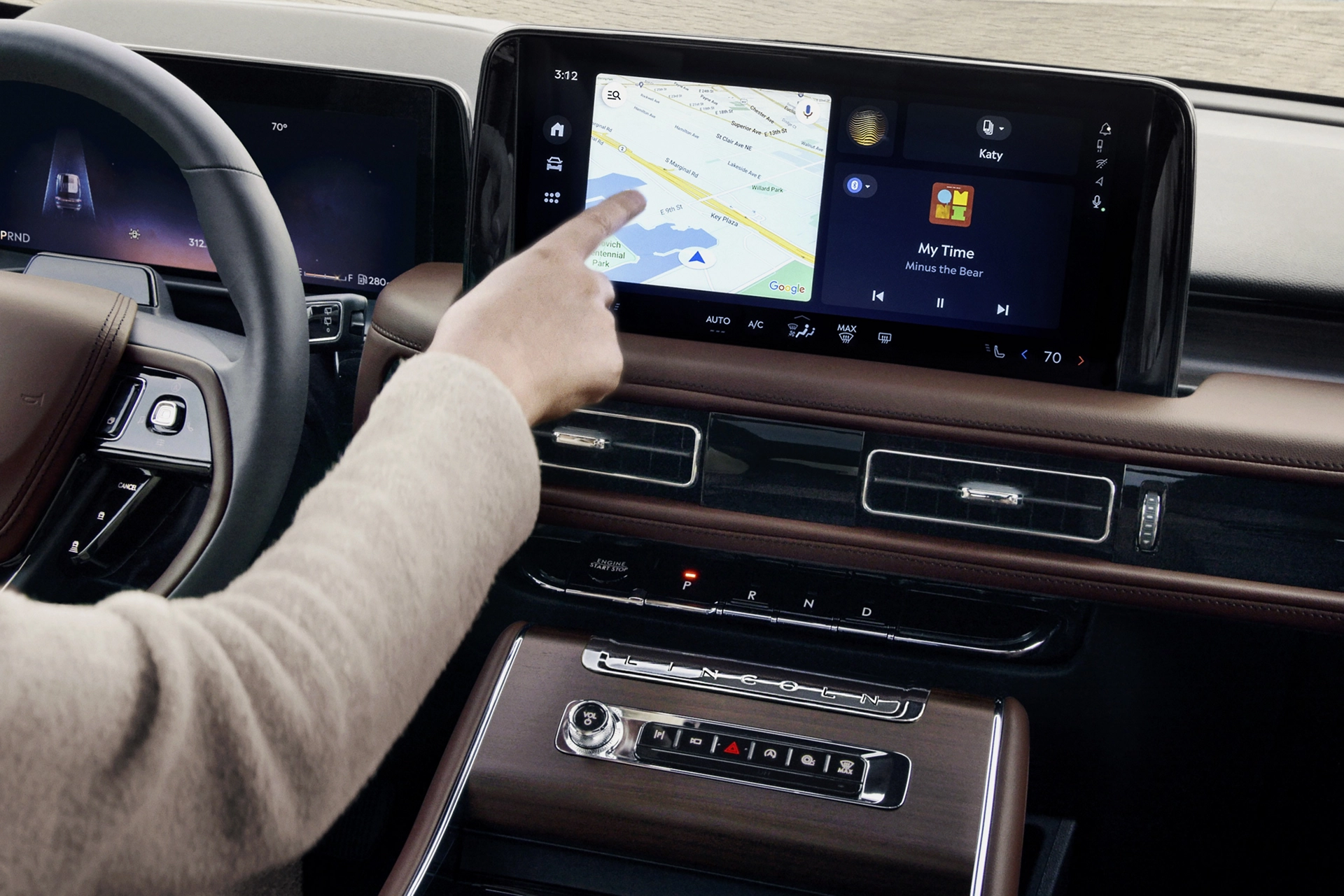 The driver of a 2025 Lincoln Aviator® SUV touches the center touchscreen