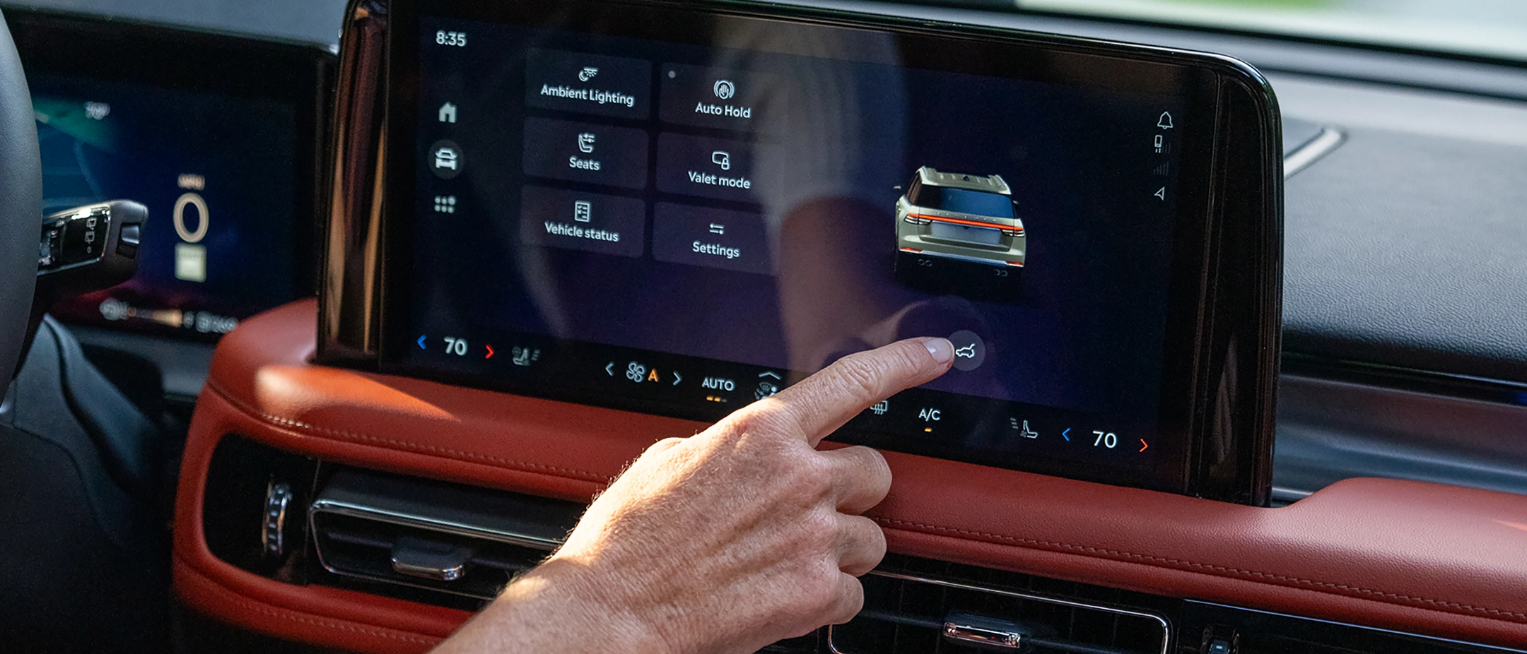 A man using the center touch screen.