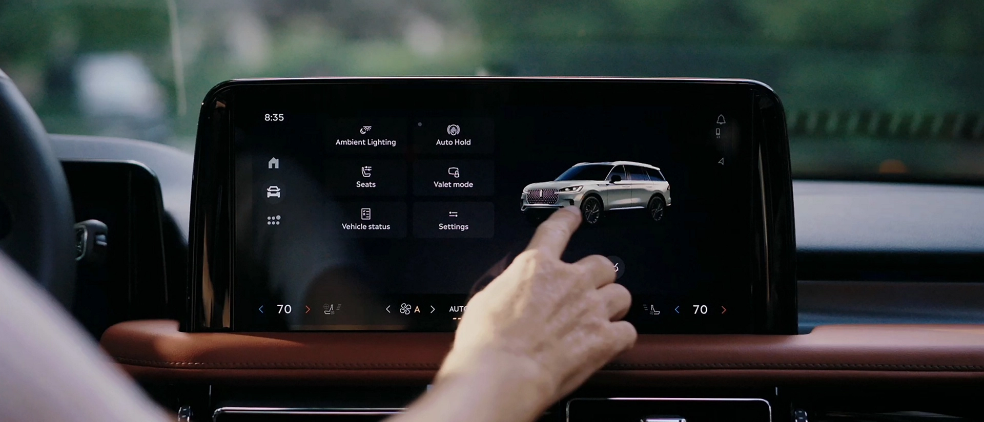 A person interacts with the center touchscreen of a 2025 Lincoln Aviator® SUV