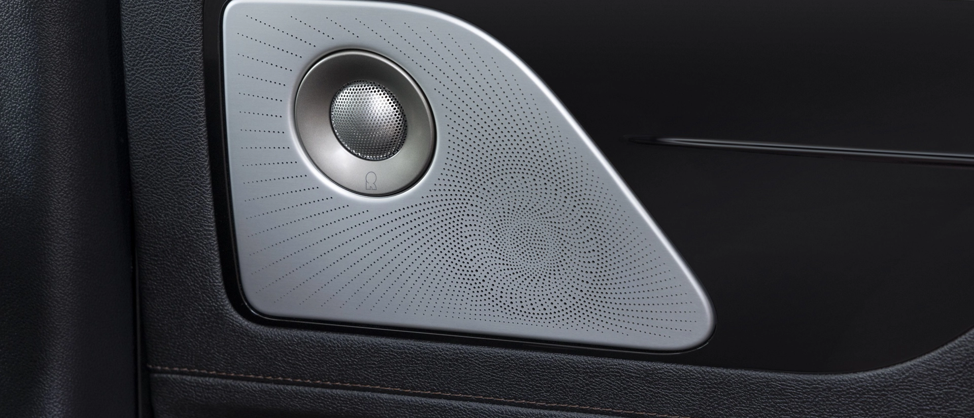 A Revel® speaker is shown on the interior door pane of a 2026 Lincoln Aviator® SUV