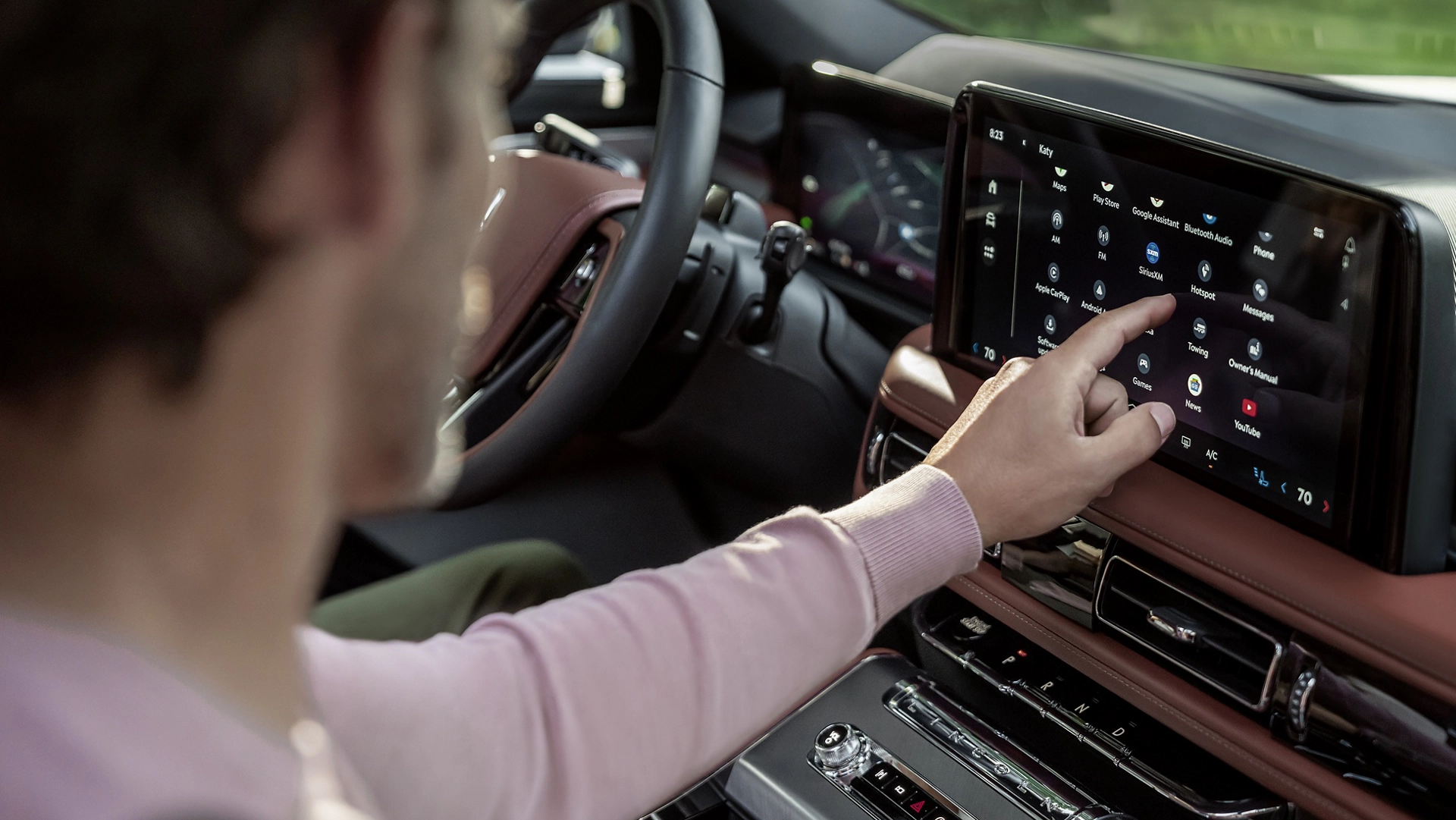 The front passenger touches the center touch screen inside a 2026 Lincoln Aviator® SUV