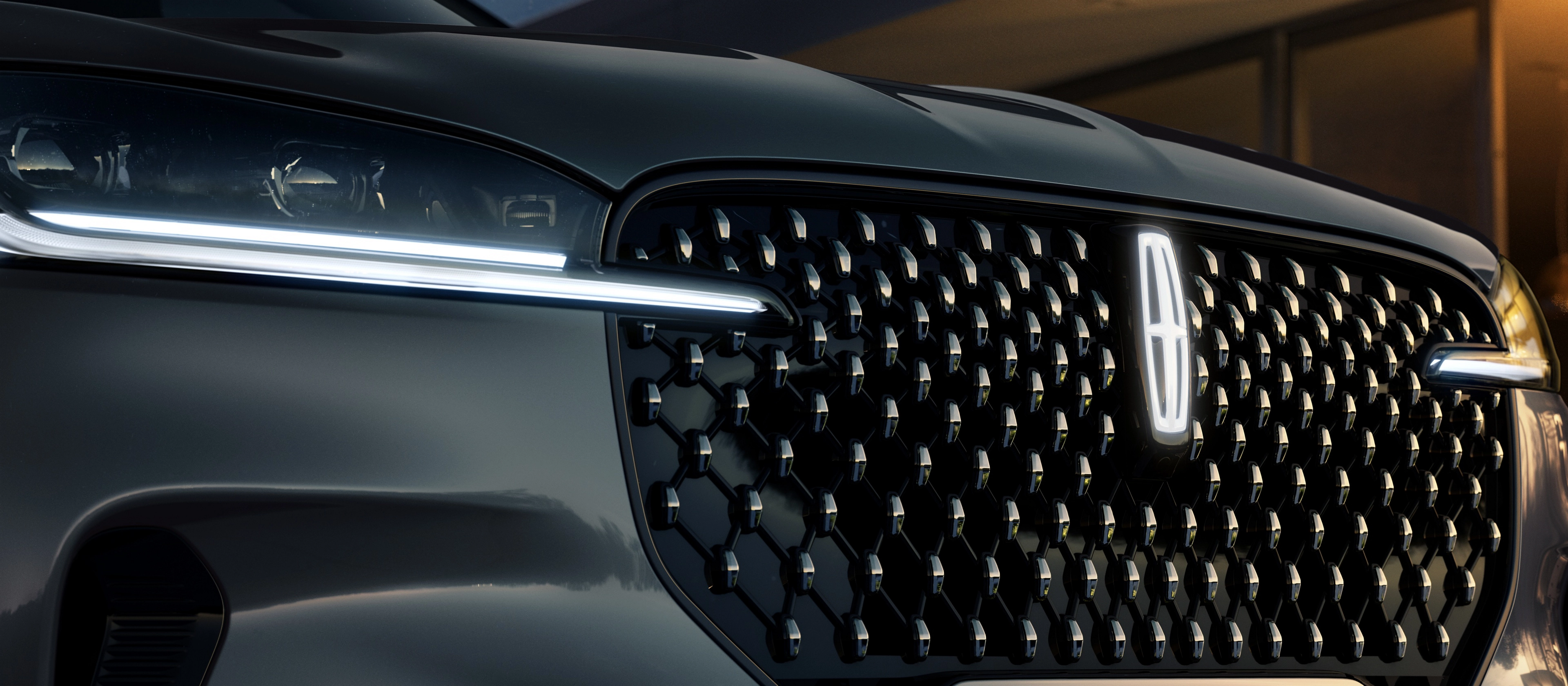 The grille of 2026 Lincoln Black Label Aviator® SUV with glowing Lincoln Star logo in the center