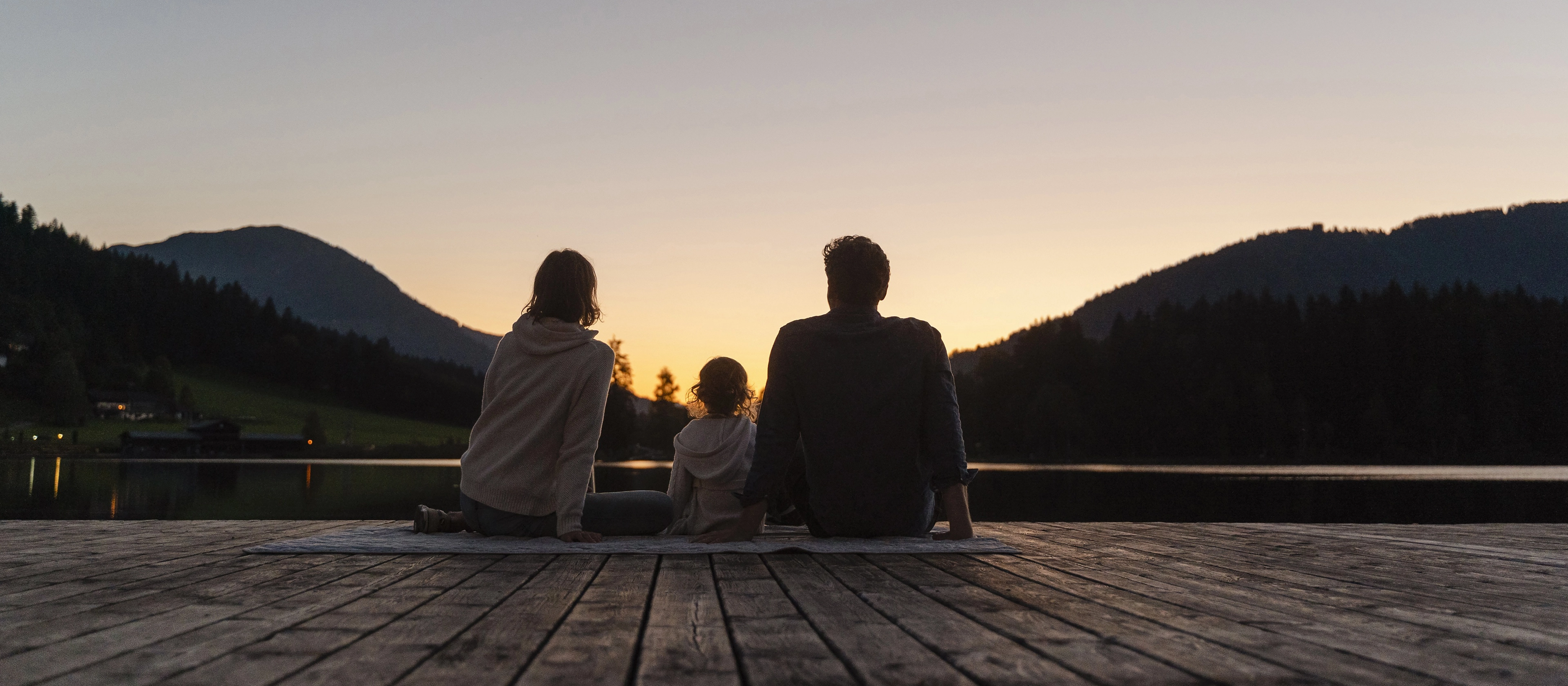 A family enjoys a sunset together