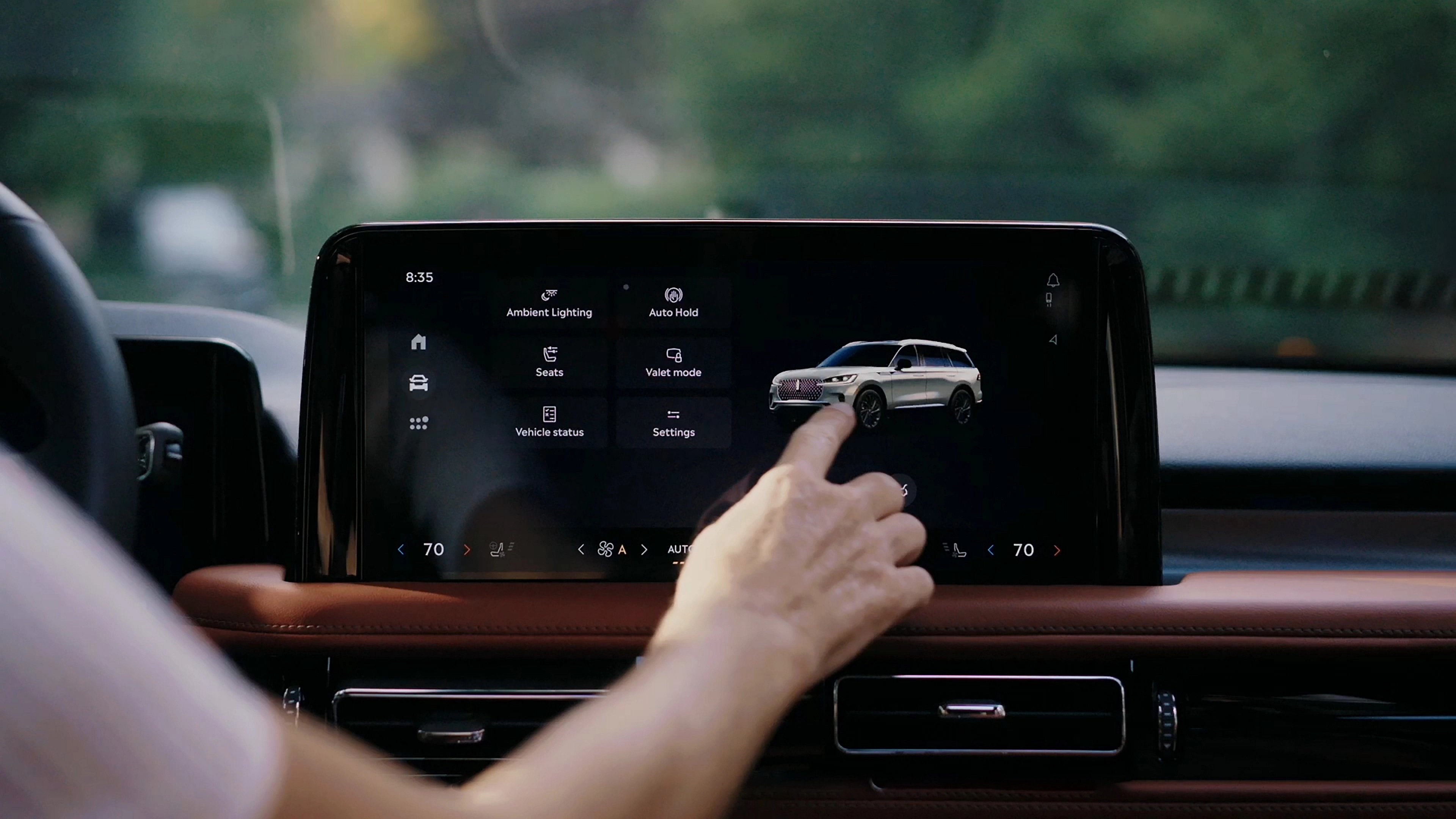 A person touches the center touchscreen to activate the power liftgate of a 2026 Lincoln Aviator® SUV