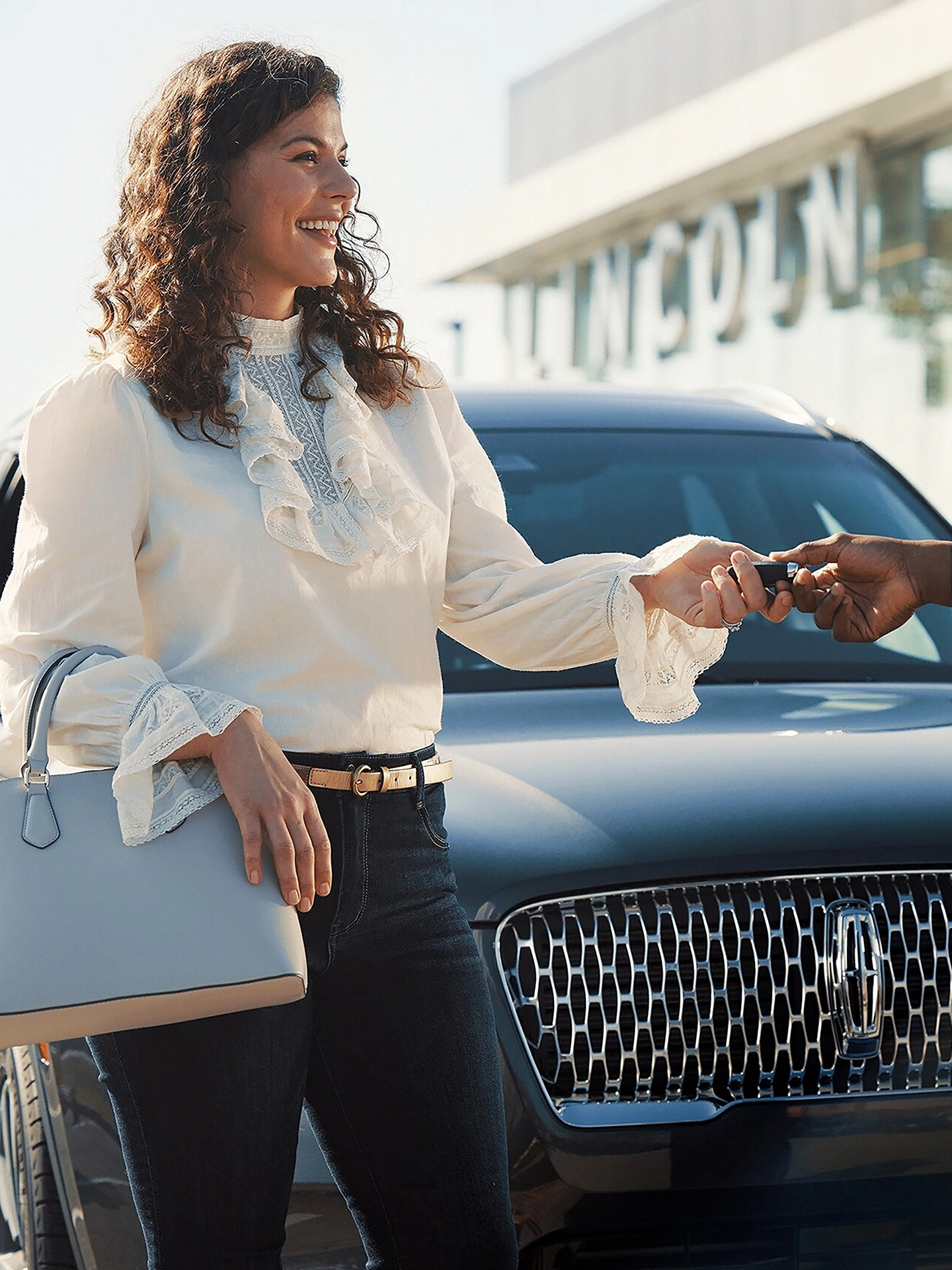 A Lincoln customer receives their keys back from a service advisor